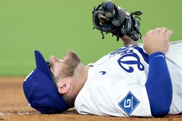 Dodgers infielder helped off field after tag